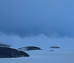 Antarctic landscape with low clouds
