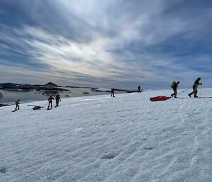 Expeditioners walking across a icy landscape