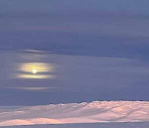Moon over an icy landscape