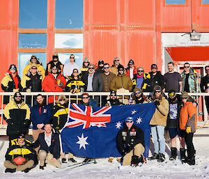 Expeditioners in an ANZAC Day photograph standing outside the Red Shed