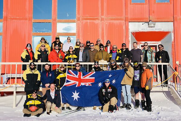 Expeditioners in an ANZAC Day photograph standing outside the Red Shed