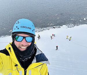 The author about to descend down an ice cliff as part of ice climbing