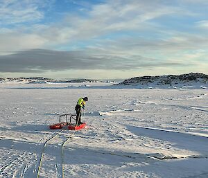 Expeditioner carrying rescue ropes on the ice