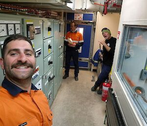 A selfie of a man in orange standing in the main power house