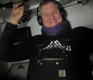 A man sitting in a truck , smiling
