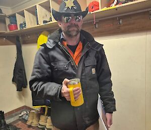 A Casey Station plumber holding a coffee cup getting ready to go to work