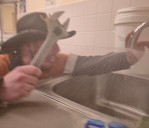 A Casey Station plumber fixing a leaking tap