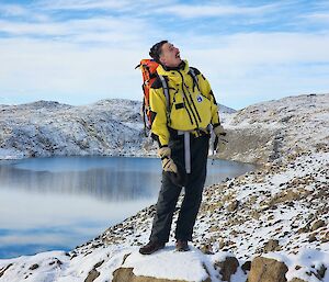 Man standing on rock looking for his next bird attack