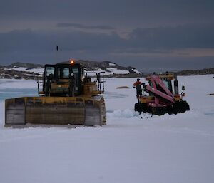 One machine recovering another from the snow bog