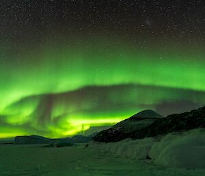 Green streaky sky over a hill
