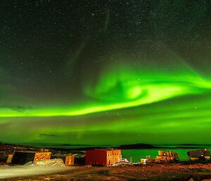 Vivid green sky over station buildings