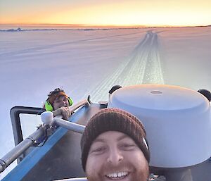 two people on vehicle on the sea ice