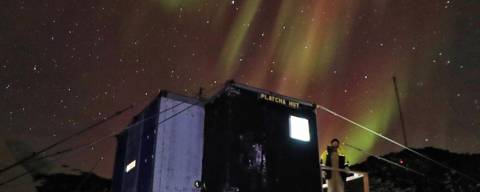 hut with aurora in sky