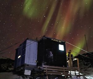 hut with aurora in sky