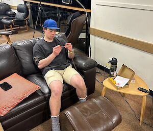 An expeditioner doing crochet
