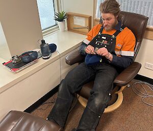 An expeditioner doing crochet