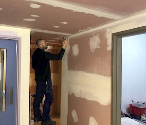 man plastering wall