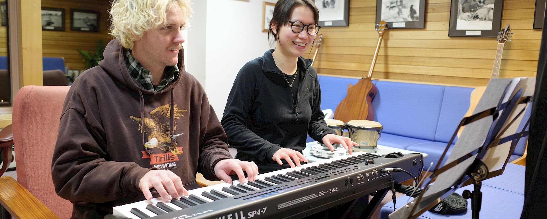 Two expeditioners sittings at a keyboard