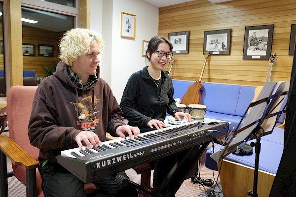 Two expeditioners sittings at a keyboard