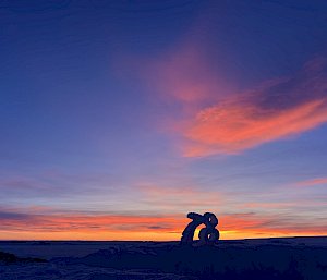 Ice carved into the number 78 against a sunset