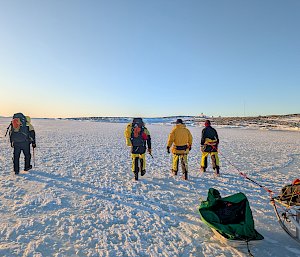 People walking on frozen sea ice