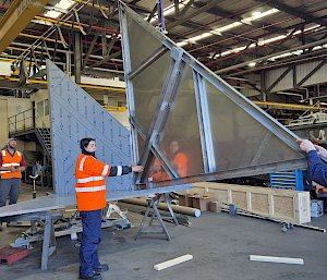 A group of staff assembling a reflector
