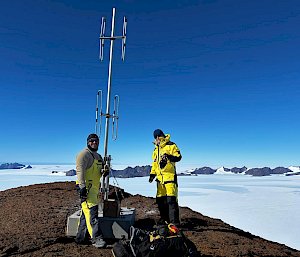 Two expeditioners repairing a communications tower