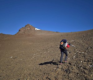 An expeditioner climbing a mountain in Antarctica