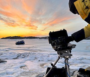 An expeditioner fixing a field camera in Antarctica