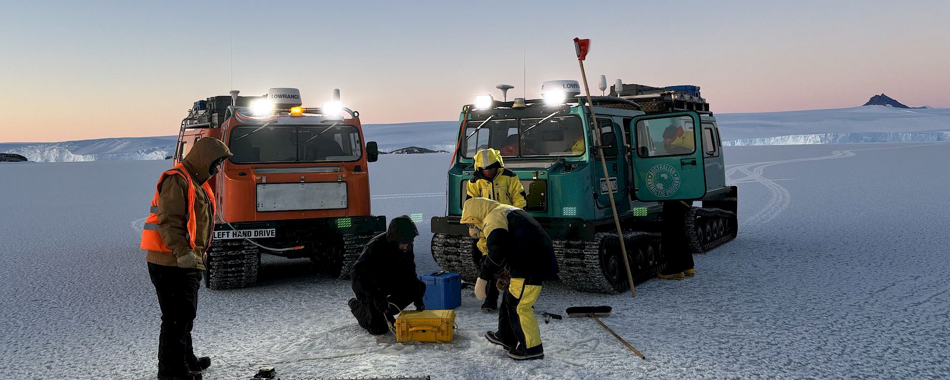 Two tractors parked on the ice in Antarctica