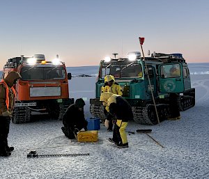 Two tractors parked on the ice in Antarctica