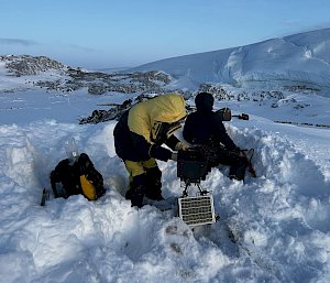 A expeditioner on a snow covered hill in Antarctica