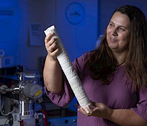 Professor Abram holds a metre-long core of white coral.
