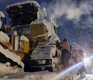 Dozer operating while it is snowing