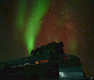 aurora in background with machine in front