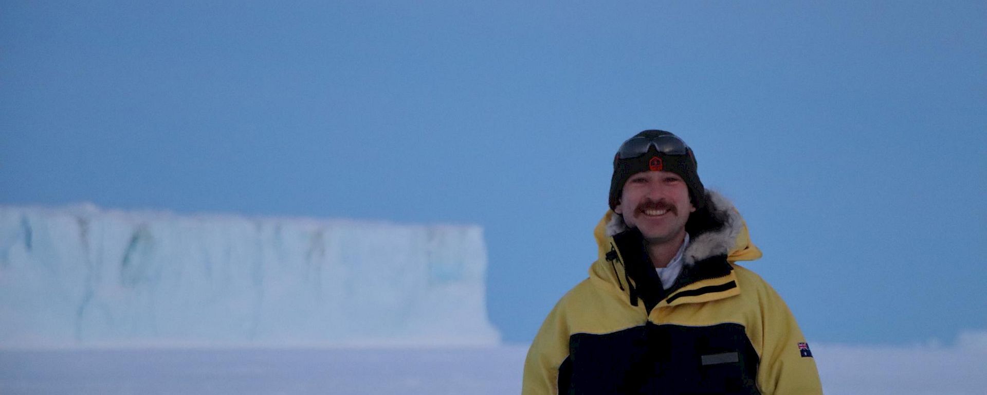 man standing in front of glacier