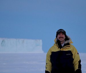 man standing in front of glacier