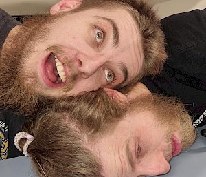 Two expeditioners with their heads on a table