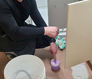 A plumber doing a job next to a sink