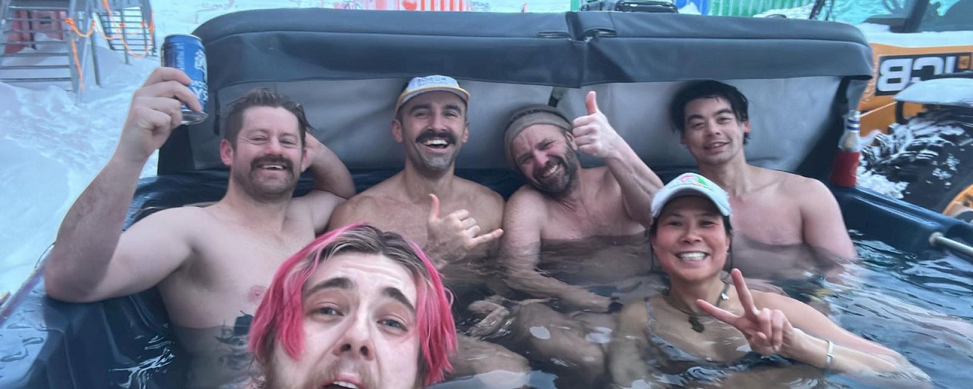 Expeditioners in a spa outdoors during the midwinter celebrations