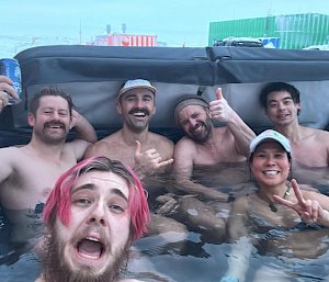 Expeditioners in a spa outdoors during the midwinter celebrations