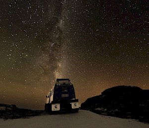 The night sky with auroras in Antarctica and a Hagglund in the foreground