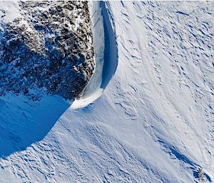 View of Tiger Rock from the air looking directly down with a big rock and a stretch of ice attached to the left of it