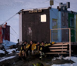 people sitting on chair in front of hut