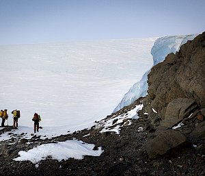 people standing on hill