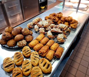 A selection of pastries and muffins on trays