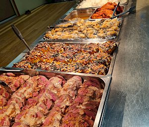 A selection of meat and vegetable dishes in a bain marie