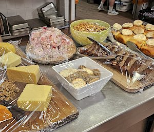 Cheese boards and other foods on trays and in bowls