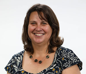 Portrait photo of a woman in a floral dress.