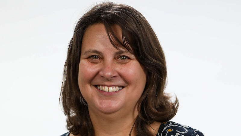 Portrait photo of a woman in a floral dress.